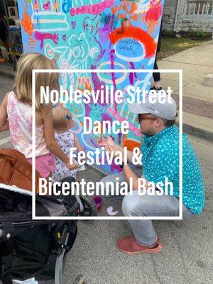 Family participating in painting murals at Noblesville Street Dance Festival.