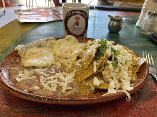 Chilaquiles verdes with creamy spicy verde sauce, white onions, cilantro, and crema mexicana