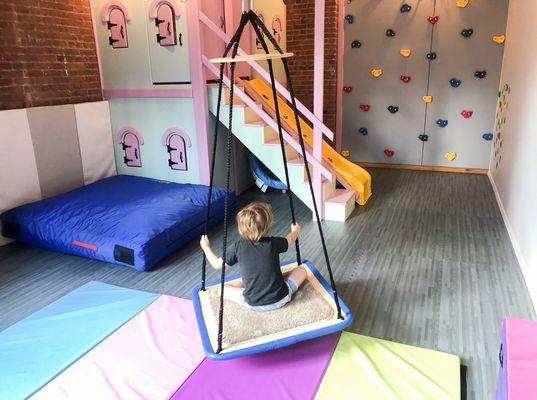 This Downtown Kid is loving the platform swing at our Tribeca location!