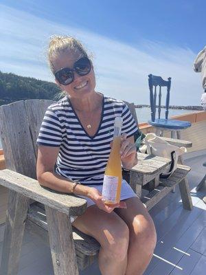 A lovely human posing with a bottle of our cider before immediately enjoying it with her friends!