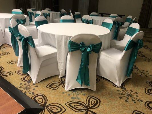 Spandex chair covers and jade satin chair sashes perfectly tied into bows