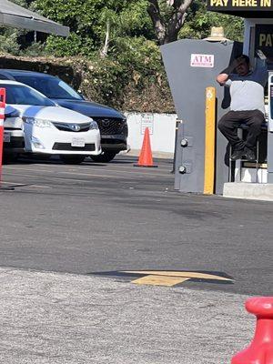 The attendant who told us they don't do pre-paid parking there. Still with his phone in his hand.