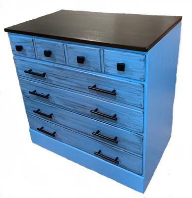 Painted a blue color for body, Black Top and a Black Glaze added to drawers with New Hardware. A customer refinish.