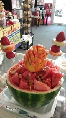 Watermelon filled with fruit, and peanuts and topped with lime juice and chamoy. Sandia loca