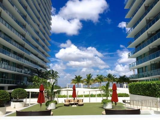 Axis on Brickell North Tower (right) and Axis on Brickell South Tower (left). Shared courtyard and lounge area amenity.