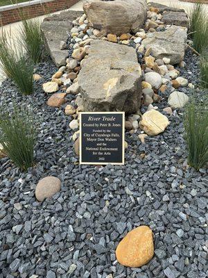 Bronze base describing the work