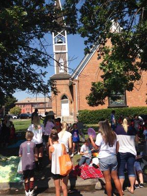 Loads of people having a blast on church grounds as they are watching the annual parade! We love to bless our community!