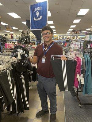 Andre, Asst. Manager-Apparel & Active wear, holding my cool new sports bras & shorts he helped me find. Julie A