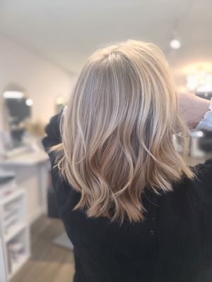 Root color touch-up, partial highlight, haircut, blow-dry + waves.