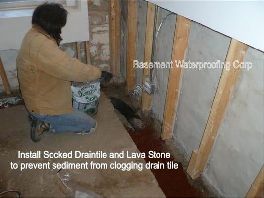 Socked drain tile and lava rock are installed.  The sock and the lava rock will stop sediment and dirt from entering the drain tile.