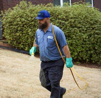 Turf Magic technician applying weed control.