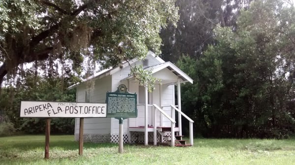 Original post office and historical marker next door to modern one..