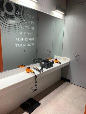 3 stations in open for hairdryers etc. I like the big mirror for prep so don't need to sit in shower stall