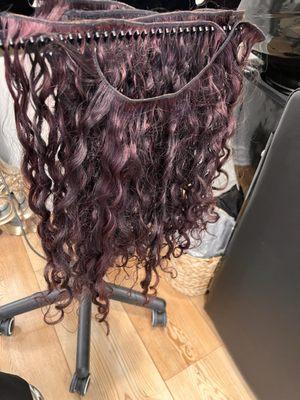 Extensions colored by her . Curl pattern significantly changed becuase of over processing the color and damaging the extensions