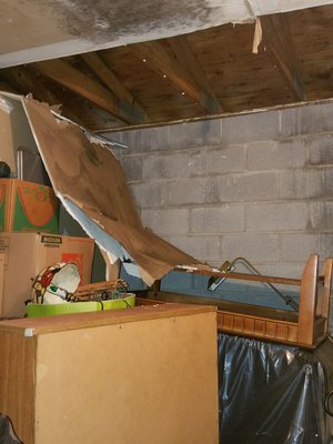 The collapsed drywall that dropped into my unit causing water damage and molding.