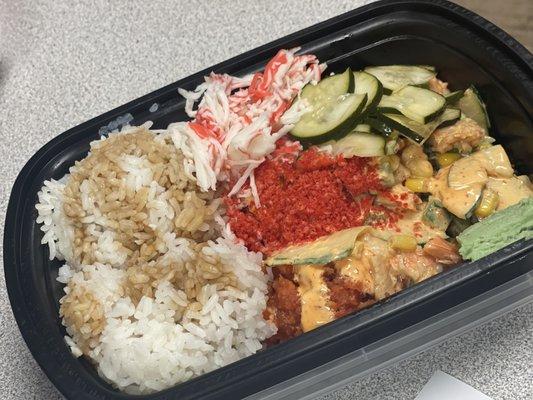 Steamed White Rice, Spicy Tuna, salmon, cooked crab, cucumbers, Cucumber Salad, octopus, spicy flakes and spicy Mayo.