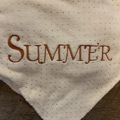 Personalized embroidery in the corner of a blanket in a beautiful premium font gold plated.