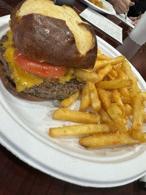 Burger and fries on pretzel bun