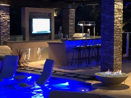 Outdoor Living Space with TV wall, Bar, and Open Patio Cover