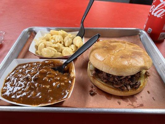 Chopped brisket sandwich, baked beans, and Mac and cheese.