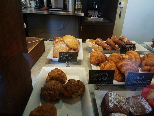 Savory scone with herbs, banana chocolate chip muffin, sweet scone in the background