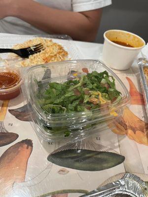 Side salad with one soup in background