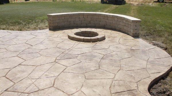 Stamped concrete patio, fire pit and seating wall.