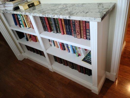 Small built-in bookcase trimmed out to match existing decor.