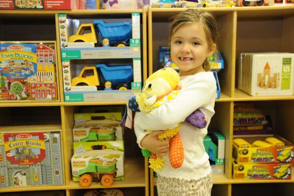 This little girl loves her new stuffed animal friend!