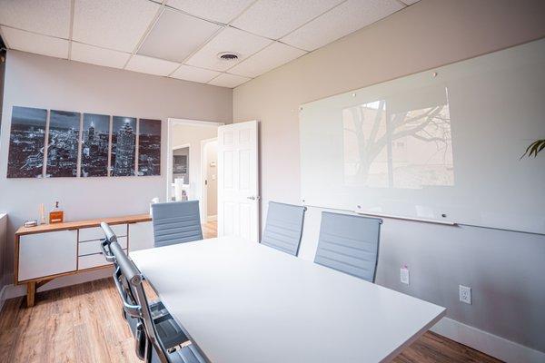 Another angle of our well lit conference room with white board.