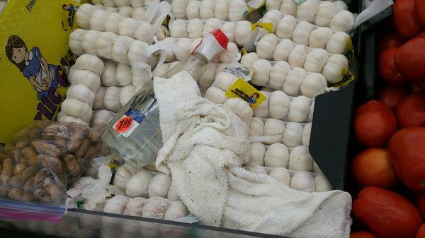 Cleaning product and dirty towel left on top of produce section!!