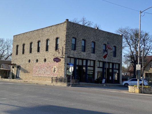 Upstairs Inn from corner across the street. The hotel entrance is the far left door on the street side, not store front side.