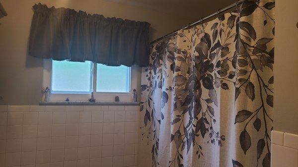 New accessories with shower curtain and valance to match new flooring.