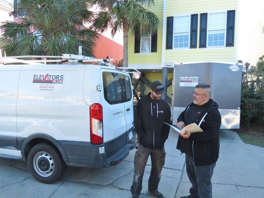 Lead Service Technician, Johnny & Project Manager, Alex, reviewing installation plans.