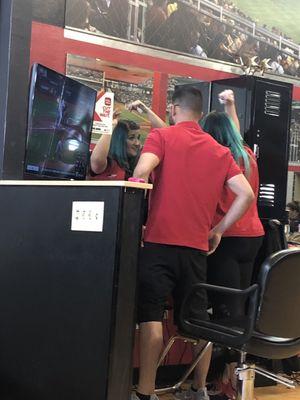 Same employee fixing her hair with the customer.