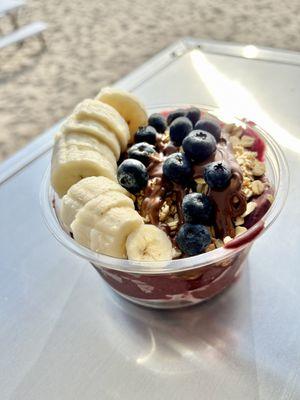 Try a tropical bowl. This one is half acai, half dragon fruit. Topped with granola, coconut flakes, honey, banana, blueberries, and Nutella.