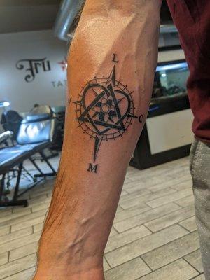 Nautical compass intertwined with the symbol for adoption and my wife and kid's initials. Exactly what I wanted.