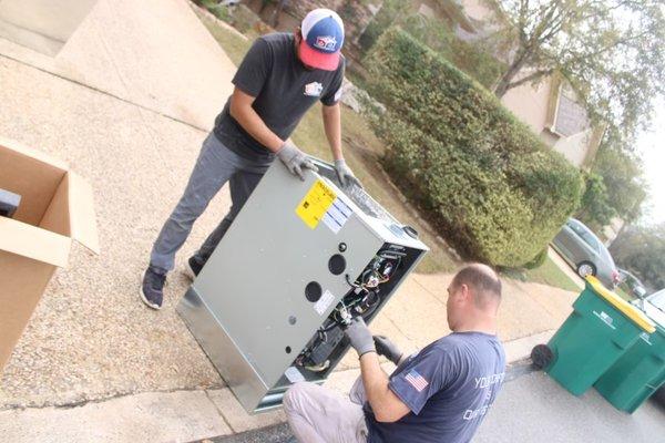 Champion AC tech prepping the unit for install.