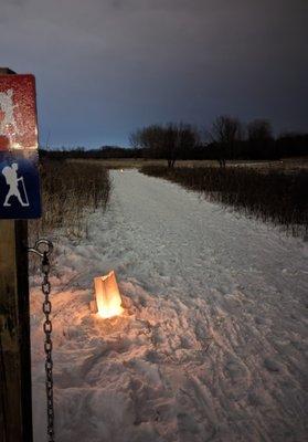 Candle lit snowshoe trail.