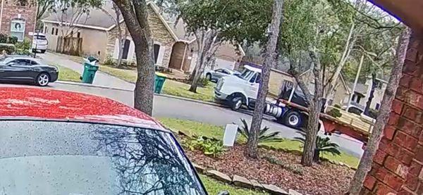 The truck running its front wheels into my neighbor's yard and its trailer into my yard.