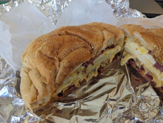 Pastrami, egg, and cheese with hot sauce.