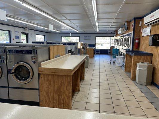 View of dryers and a few folding counters