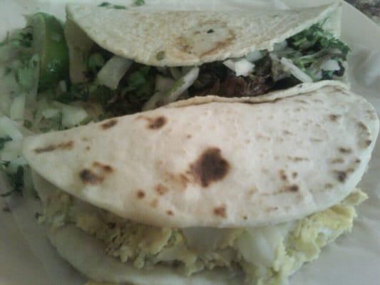 Delicious Barbacoa taco w/ cilantro and onions on corn tortilla and a big potato and a egg taco! :)