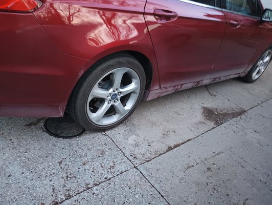 Dirt and grime still left on the bottom of the car after purchasing the ultimate wash package.