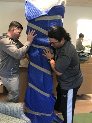 Carlos and Christian carefully moving a 140 year old grandfather clock.