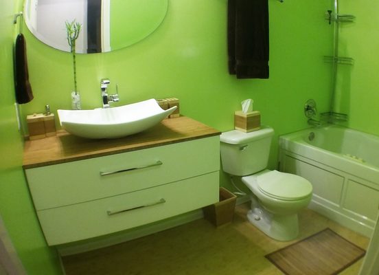 Bathroom after with custom floating vanity, jacuzzi tub, and bamboo floor.