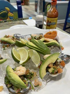 Ostiones al charro negro  6 pieces Oyster with cooked shrimp, tomato, cilantro and avocado