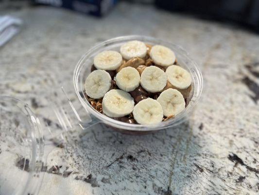 A simple, yet delicious M.C. bowl. It comes with acai base, no honey, granola, nutella, peanut butter, and bananas!