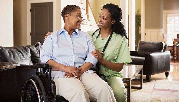 Caregiver assisting client with wheelchair