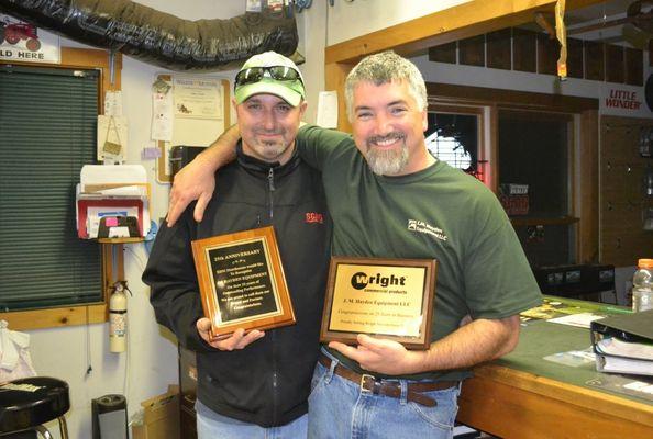 Ray and John holding 25th anniversary plaques from EDM Distributors and Wright MFG.